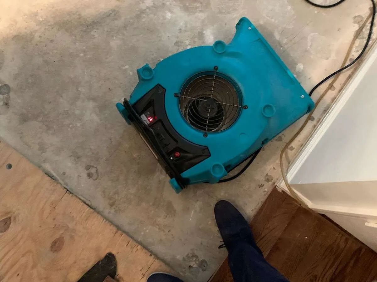 Air mover drying subfloor during Commercial Water Damage Restoration in Palm City